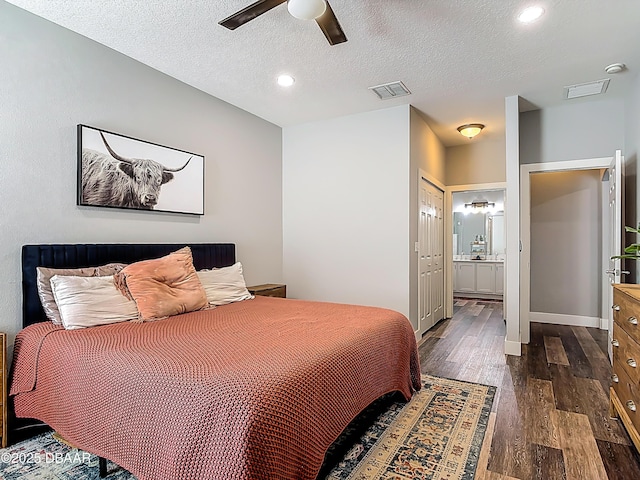 4225 Bristle Cone Way, Port Orange, FL 32129 - bedroom featuring dark wood-type flooring, a textured ceiling, a ceiling fan, ensuite bath, and recessed lighting