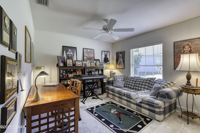 living area featuring a ceiling fan, baseboards, visible vents, a textured ceiling, and carpet flooring