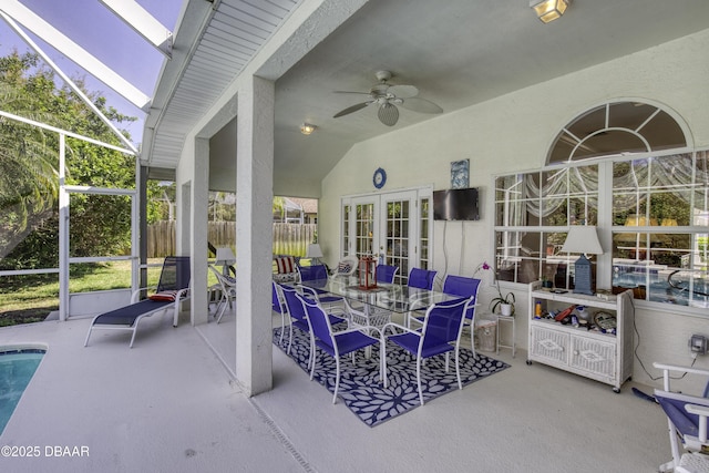 view of patio featuring fence, a lanai, french doors, an outdoor pool, and ceiling fan