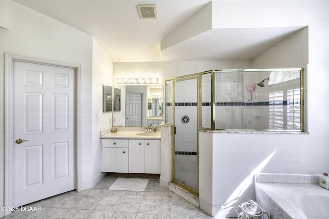 bathroom featuring visible vents, a textured ceiling, a shower stall, a bathtub, and vanity