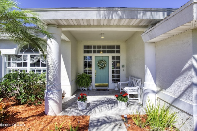 view of exterior entry featuring stucco siding