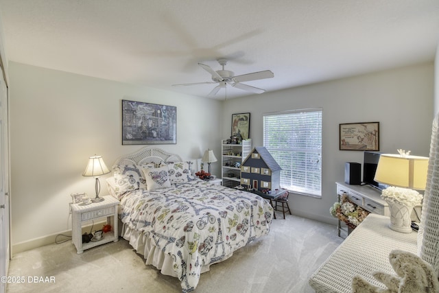 bedroom featuring ceiling fan, baseboards, and light carpet