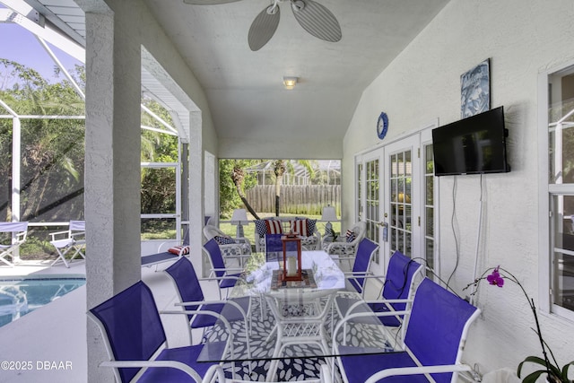 view of patio featuring a ceiling fan, fence, french doors, glass enclosure, and a fenced in pool