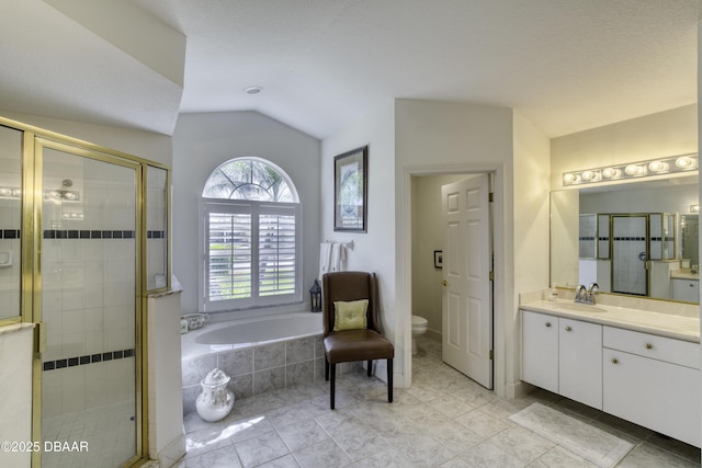 bathroom with a bath, a stall shower, and lofted ceiling