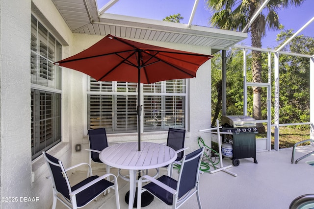 view of patio / terrace featuring area for grilling, a lanai, and outdoor dining space