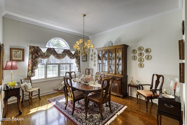 dining area with baseboards, dark wood finished floors, ornamental molding, a textured ceiling, and a notable chandelier