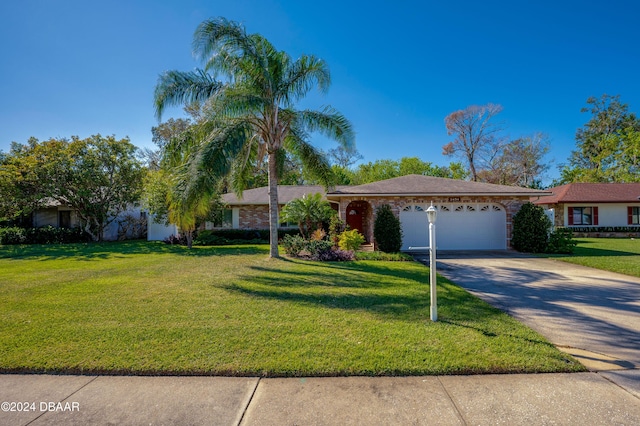 single story home featuring a garage and a front yard