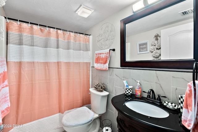 4 Oceans W Blvd Unit 507D, Daytona Beach Shores, FL 32118 - bathroom featuring walk in shower, tile walls, vanity, and toilet