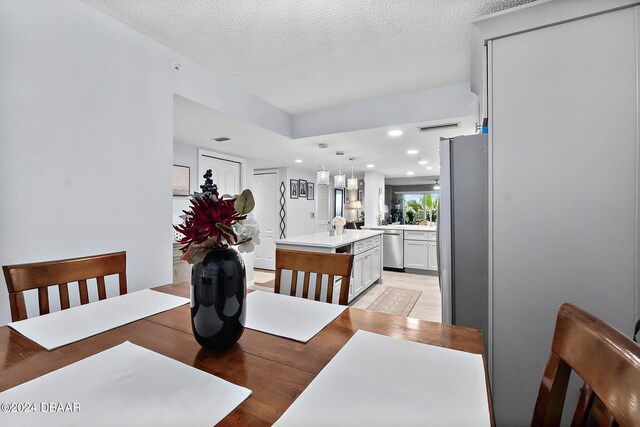 4 Oceans W Blvd Unit 507D, Daytona Beach Shores, FL 32118 - dining room featuring light hardwood / wood-style floors and a textured ceiling
