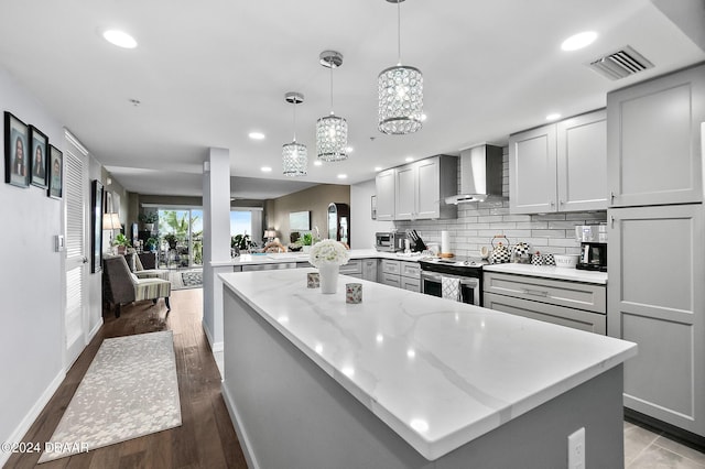 4 Oceans W Blvd Unit 507D, Daytona Beach Shores, FL 32118 - kitchen featuring gray cabinets, decorative light fixtures, kitchen peninsula, wall chimney range hood, and stainless steel electric range