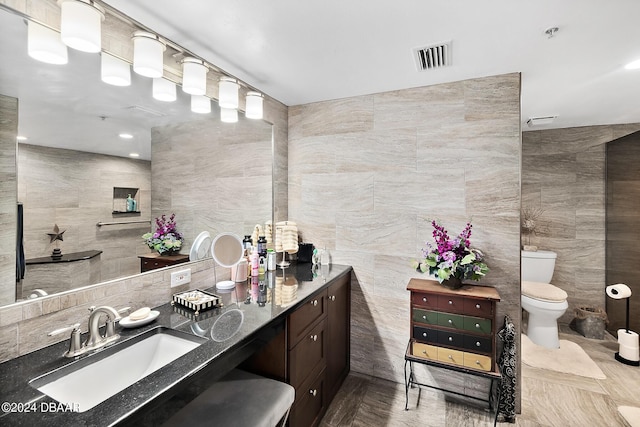4 Oceans W Blvd Unit 507D, Daytona Beach Shores, FL 32118 - bathroom featuring vanity, tile walls, and toilet