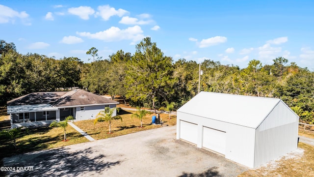 view of outbuilding featuring a lawn and a garage