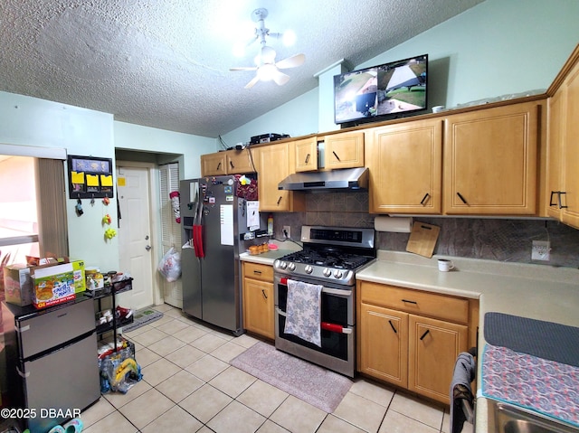 20 Lake Meadow Way, Ormond Beach, FL 32174 - kitchen with appliances with stainless steel finishes, under cabinet range hood, vaulted ceiling, light countertops, and backsplash