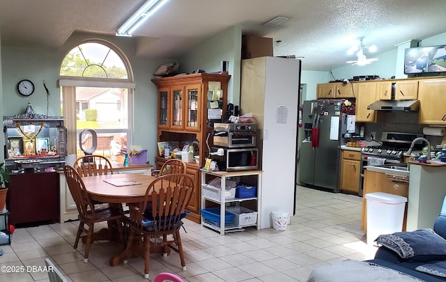 20 Lake Meadow Way, Ormond Beach, FL 32174 - dining area with lofted ceiling, a ceiling fan, light tile patterned flooring, and a textured ceiling