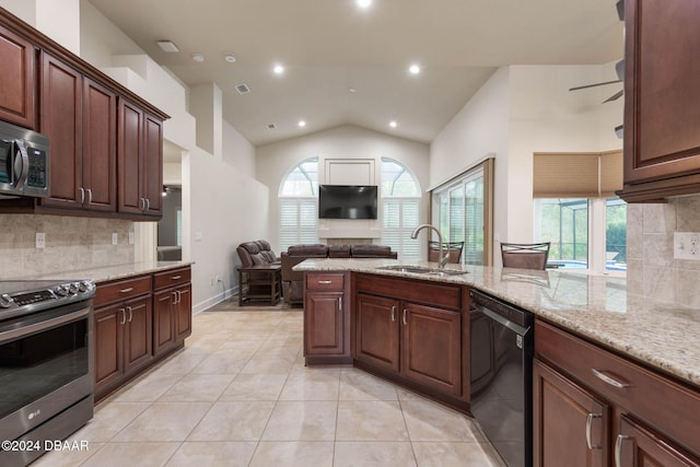 kitchen featuring appliances with stainless steel finishes, tasteful backsplash, lofted ceiling, and sink