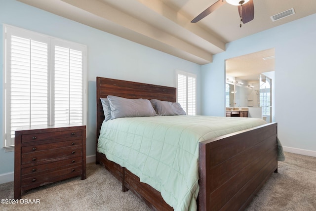 bedroom featuring ensuite bath, ceiling fan, and light colored carpet