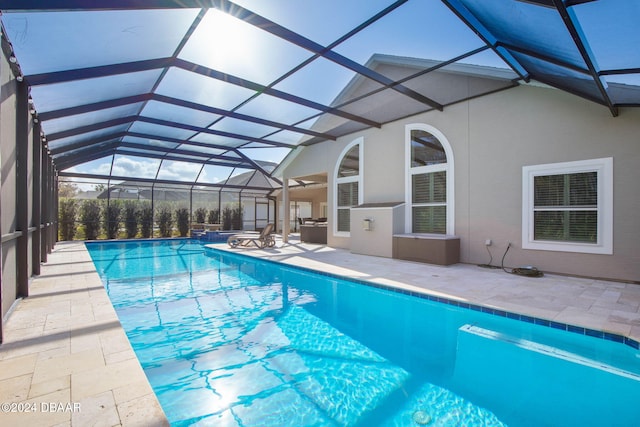 view of swimming pool with a patio and glass enclosure