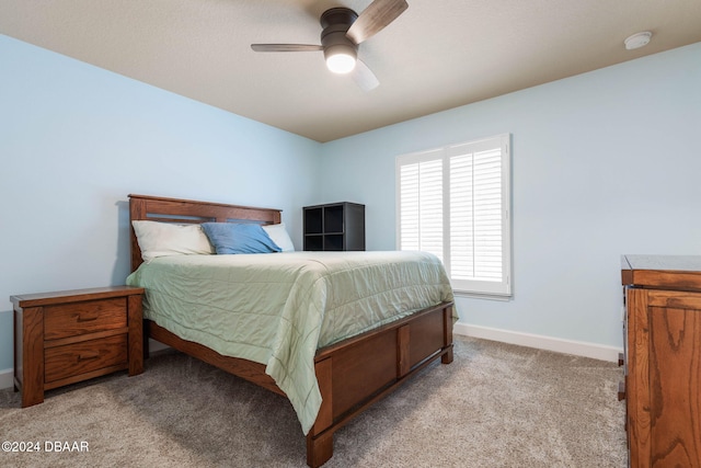 bedroom featuring ceiling fan and light carpet