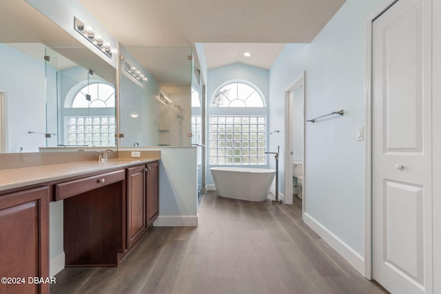 full bathroom with vanity, hardwood / wood-style flooring, independent shower and bath, toilet, and lofted ceiling