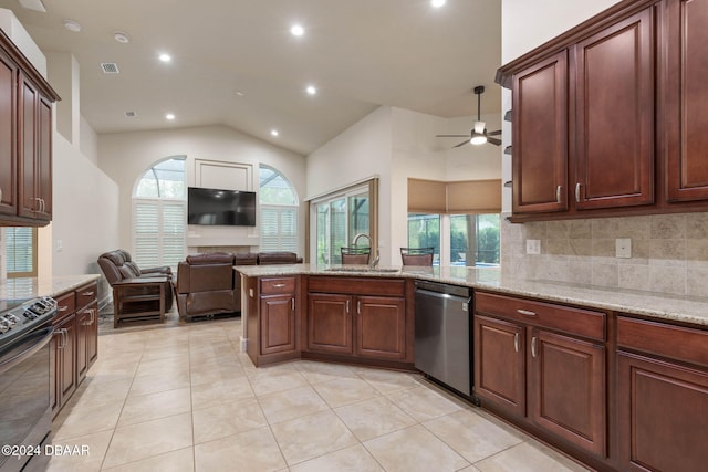 kitchen featuring light stone countertops, stainless steel appliances, vaulted ceiling, sink, and light tile patterned floors