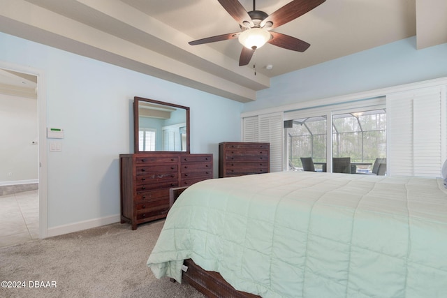 bedroom with ceiling fan, access to exterior, light carpet, and multiple windows