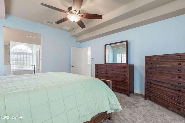 carpeted bedroom with ceiling fan and multiple windows