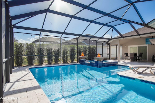 view of swimming pool with an in ground hot tub, a patio, and glass enclosure