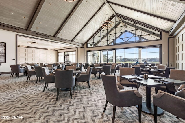 dining area with carpet flooring, beamed ceiling, high vaulted ceiling, and wooden ceiling