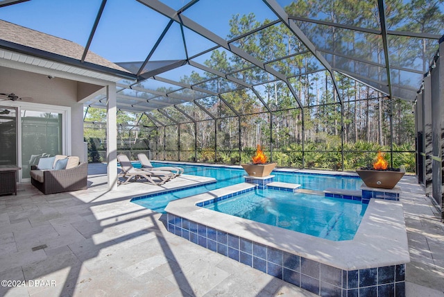 view of swimming pool featuring an in ground hot tub, a patio area, and a lanai