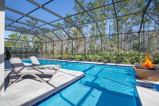 view of pool with a lanai and a patio