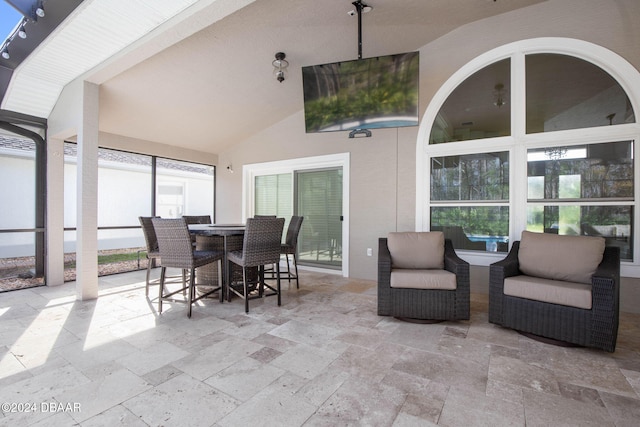 sunroom featuring lofted ceiling