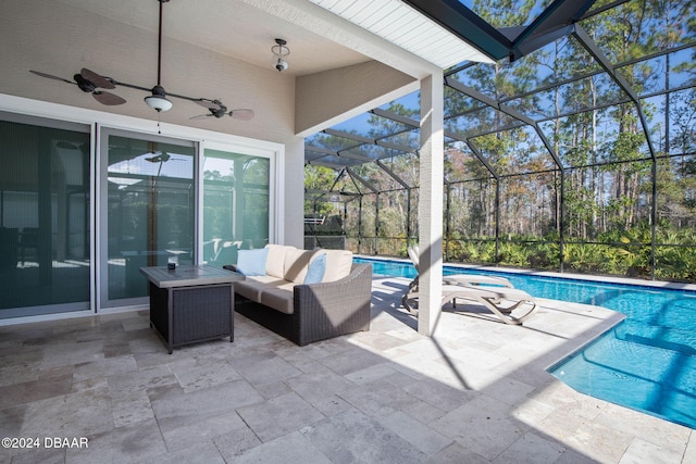 view of patio featuring ceiling fan, an outdoor living space, and glass enclosure