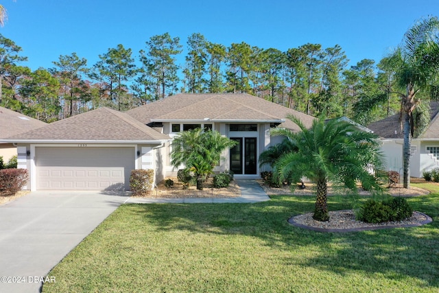 view of front of house with a front lawn and a garage