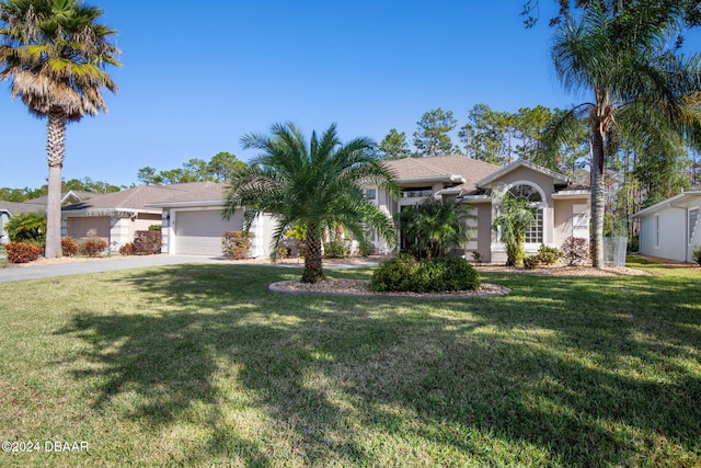 view of front facade with a front yard and a garage