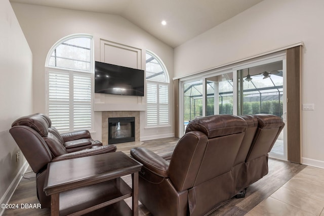 living room featuring wood-type flooring, vaulted ceiling, and a healthy amount of sunlight