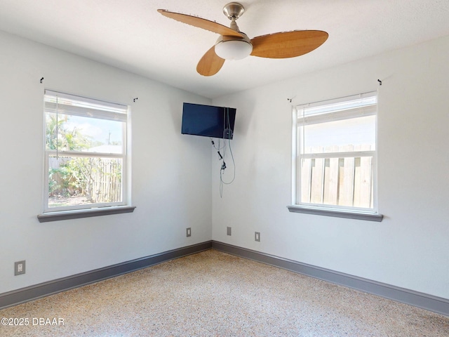 650 S Pine St, New Smyrna Beach, FL 32169 - spare room with baseboards, ceiling fan, and speckled floor