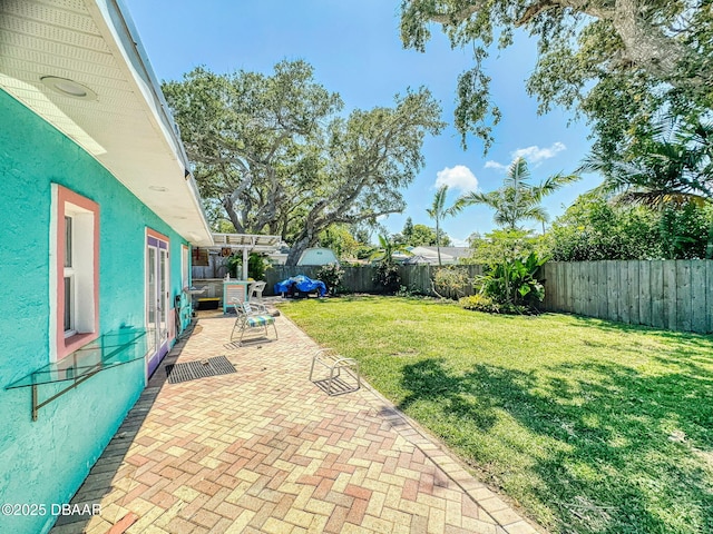 650 S Pine St, New Smyrna Beach, FL 32169 - view of yard featuring a fenced backyard and a patio