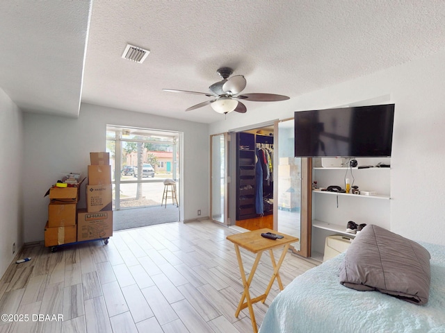650 S Pine St, New Smyrna Beach, FL 32169 - bedroom with visible vents, access to exterior, baseboards, ceiling fan, and a textured ceiling