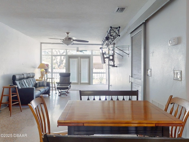 650 S Pine St, New Smyrna Beach, FL 32169 - dining space with a ceiling fan, a textured wall, and visible vents