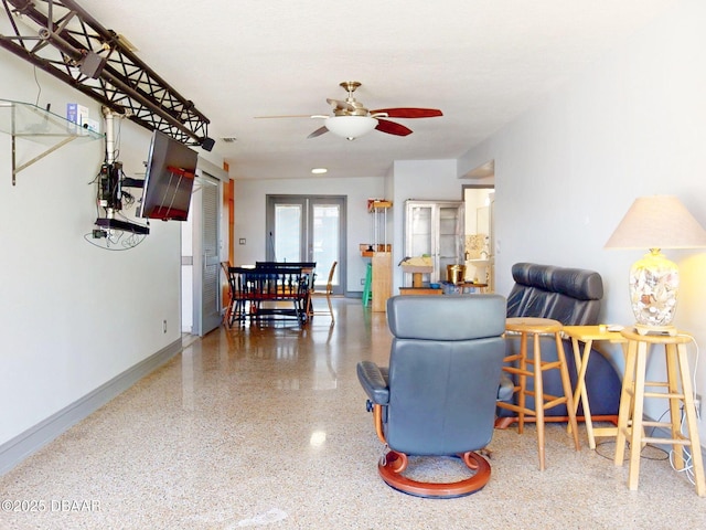 650 S Pine St, New Smyrna Beach, FL 32169 - living area featuring baseboards, speckled floor, and ceiling fan