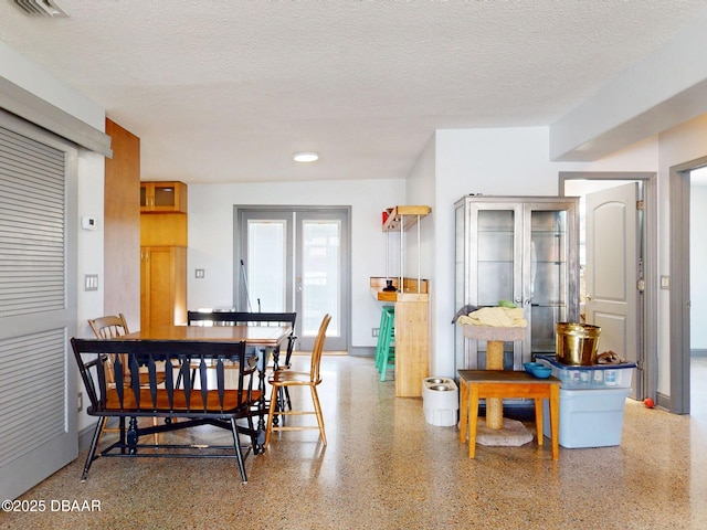 650 S Pine St, New Smyrna Beach, FL 32169 - dining room featuring a textured ceiling, visible vents, and speckled floor