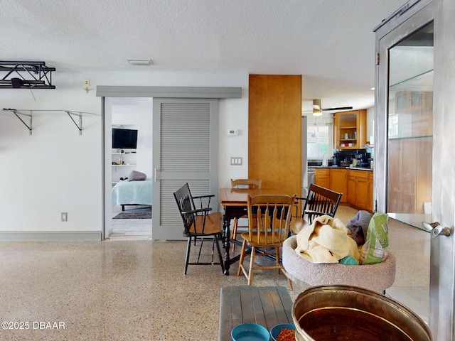650 S Pine St, New Smyrna Beach, FL 32169 - dining area with a textured ceiling, visible vents, ceiling fan, and light speckled floor