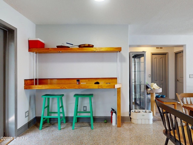 650 S Pine St, New Smyrna Beach, FL 32169 - interior space featuring baseboards, open shelves, speckled floor, and visible vents