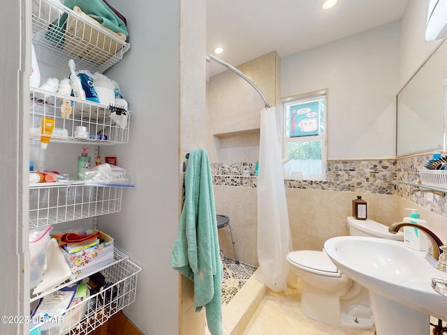 650 S Pine St, New Smyrna Beach, FL 32169 - bathroom featuring tile walls, a shower stall, a sink, toilet, and recessed lighting