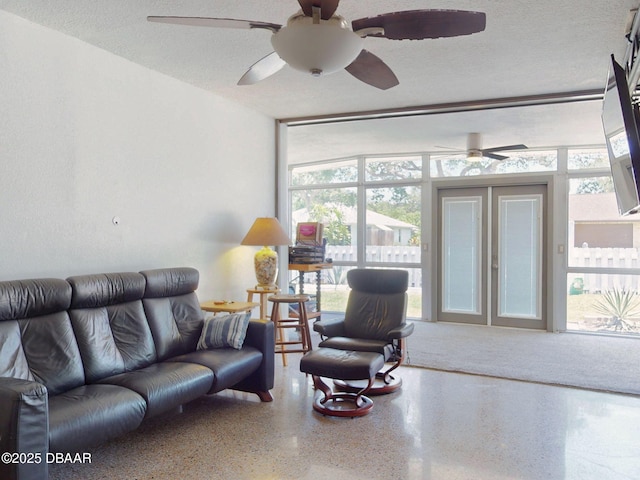 650 S Pine St, New Smyrna Beach, FL 32169 - living room featuring speckled floor, a ceiling fan, and a wealth of natural light
