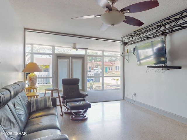 650 S Pine St, New Smyrna Beach, FL 32169 - living room featuring baseboards, ceiling fan, speckled floor, and a textured ceiling