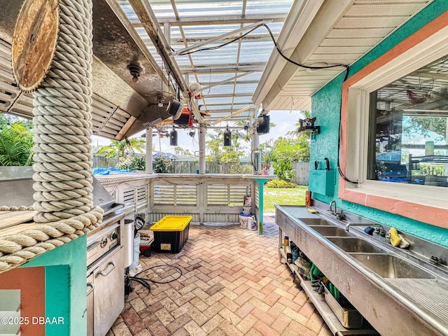 650 S Pine St, New Smyrna Beach, FL 32169 - view of patio featuring a sink, exterior kitchen, and fence