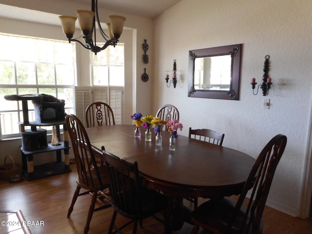 dining area featuring an inviting chandelier and hardwood / wood-style floors