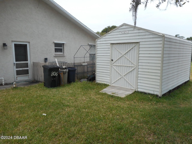 view of outbuilding with a lawn