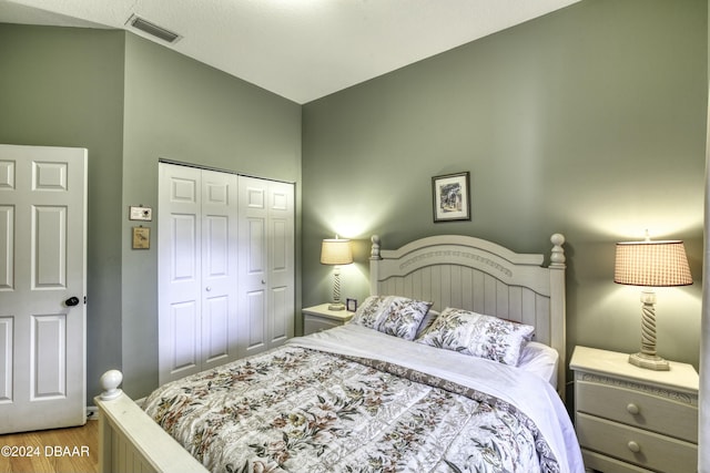 bedroom with light wood-type flooring and a closet